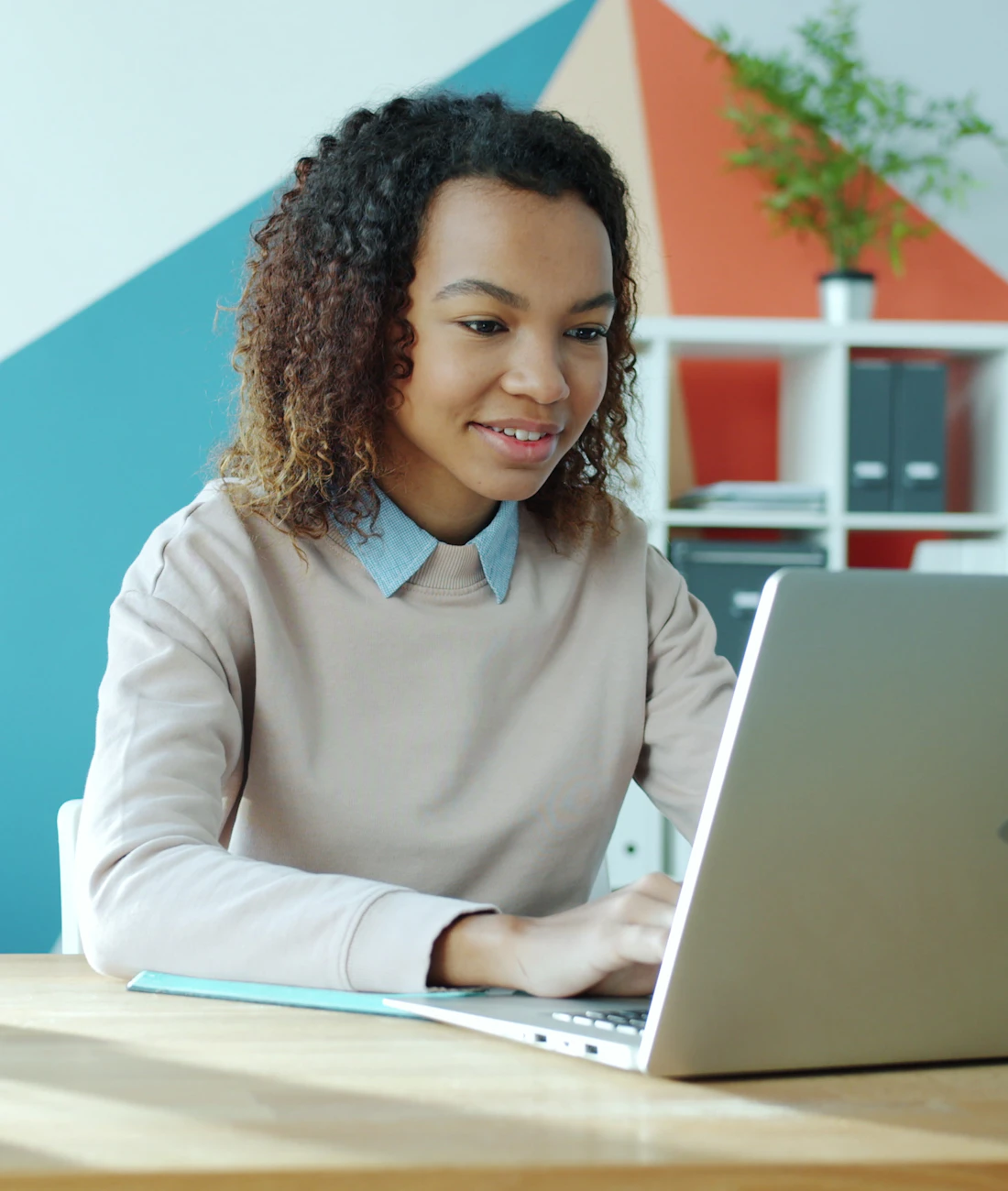 An NDIS provider leader reviewing compliance evidence confidently on a laptop